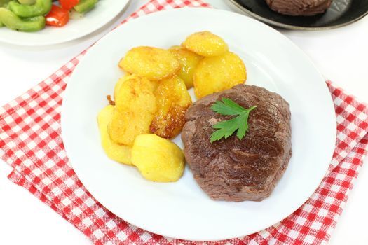 Ostrich steak with baked potatoes and peppers - artichokes - Vegetables