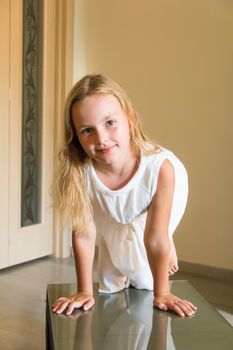 Cute girl with blond long hair and blue eyes
