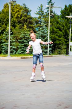Photo of cute girl on roller skates in summer