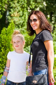 Photo of smiling mother and daughter in summer