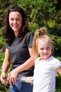 Photo of smiling mother and daughter in summer