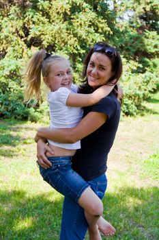 Photo of mother and daughter playing in summer