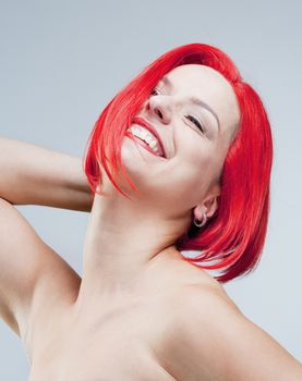 Portrait of a Young Woman in Red Wig - Isolated on Gray