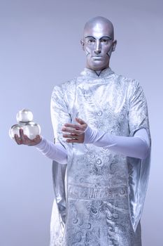 Magician with Glass Balls in Stage Makeup and Costume