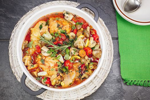 Braised chicken dish in a tomato sauce with  wine, vegetable and spices, ready to eat.