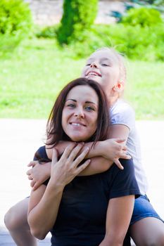 Photo of mother and daughter playing in summer