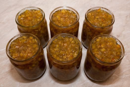 Homemade jam from Cucurbita pepo with lemon in glass jars on the kitchen table