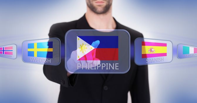 Hand pushing on a touch screen interface, choosing language or country, Philippines