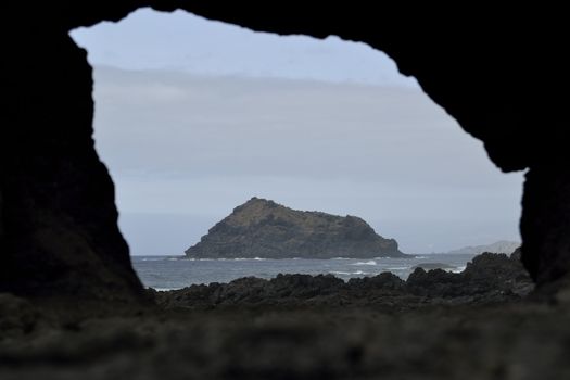 Roque de Garachico through a hole in a rock