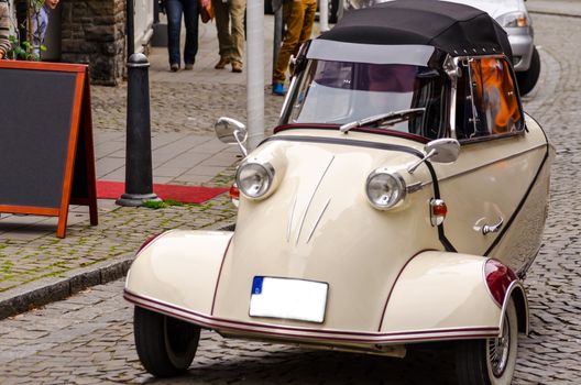 Essen Kettwig, Nrw, Germany - March 30, 2014: Essen Kettwig downtown, Messerschmitt cabin scooter on a city transit at a oldtimer rally. 
Produced by the Messerschmitt company.
 Designer of the vehicle was the engineer Fritz Fend.