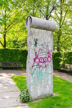 Mülheim Ruhr,Nrw, Germany - April 23, 2014: 
Original member of the Berlin Wall with the typical Gafitti placed in the park, near Ringlockschuppen.