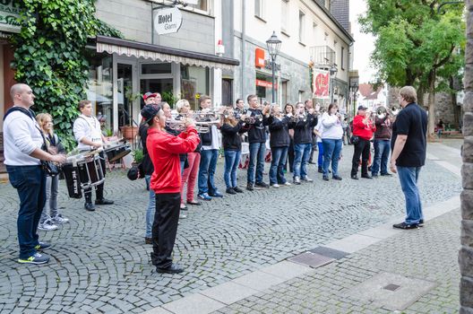 Hattingen old town, Nrw, Germany - October 10, 2014: Members of a marching band chapel to open a restaurant in the old town of Hattingen. In Vordergurnd the conductor.