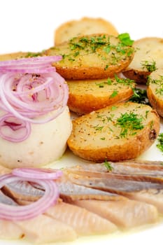 Roast potatoes with salted hering and onion rings