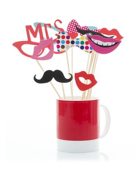 Photo Booth Props in a Red Mug on a White Background