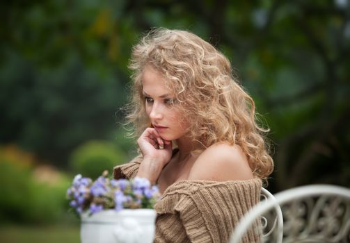young beautiful woman is resting in the garden