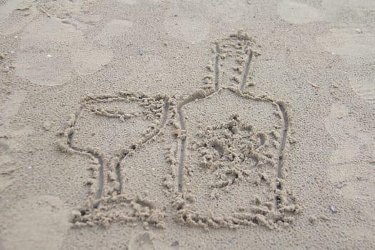 Photo shows a detail of the sign in the beach sand.