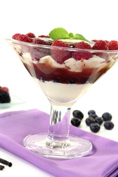 Layered dessert with raspberries on a light background