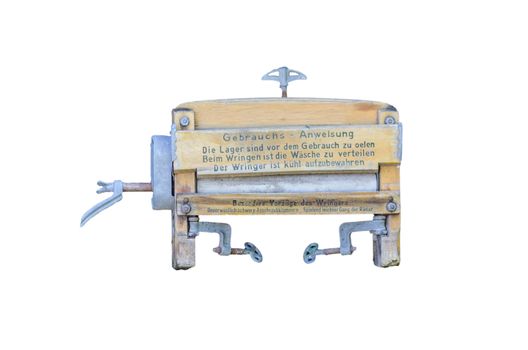 Antique wringer washing against a white background.
Old mangle - used for pressing sheets, linen and clothes before the advent of electric irons. Smaller or more delicate items were pressed using irons heated on a stove.