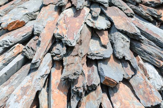 Carefully piled stone slabs in a heap.