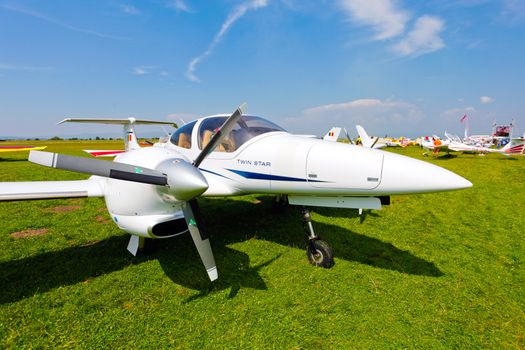 Brasov, Romania - August 12, 2010: White airplane on a green grass field prepared to take off for a flight show