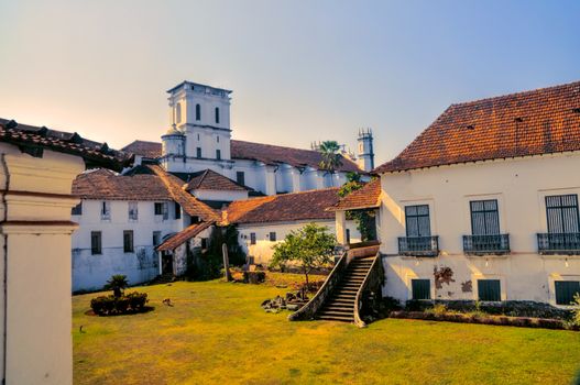 Scenic yard and old houses in historical town of Old Goa in India