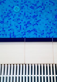 Close up view of tiles of swimming pool with blue water