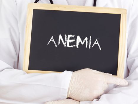 Doctor shows information on blackboard: anemia