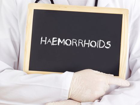 Doctor shows information on blackboard: haemorrhoids