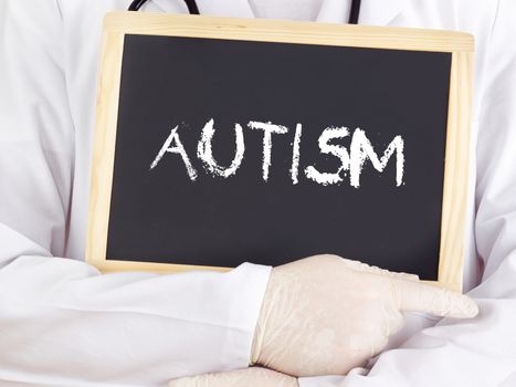 Doctor shows information on blackboard: autism