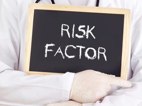 Doctor shows information on blackboard: risk factor