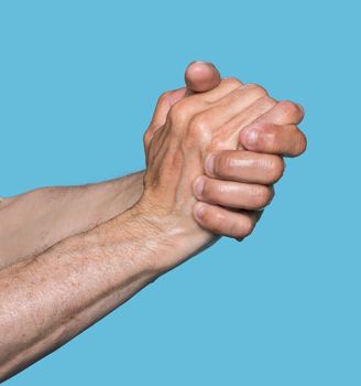 Wet hands of an elderly man isolated on blue