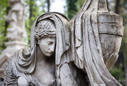 Old statue on grave in the Lychakivskyj cemetery of Lviv, Ukraine.