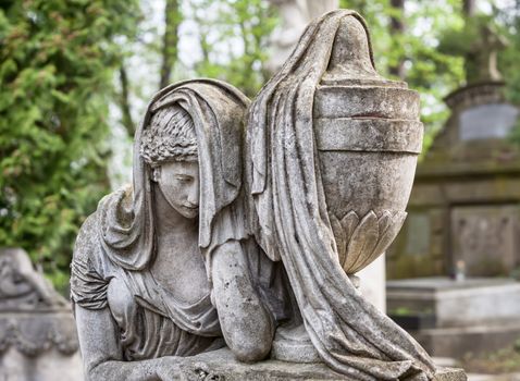 Old statue on grave in the Lychakivskyj cemetery of Lviv, Ukraine.