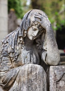 Old statue on grave in the Lychakivskyj cemetery of Lviv, Ukraine.
