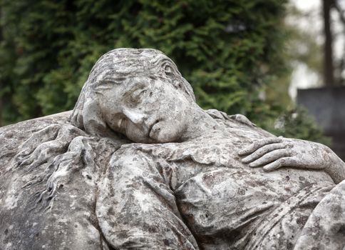 Old statue on grave in the Lychakivskyj cemetery of Lviv, Ukraine.