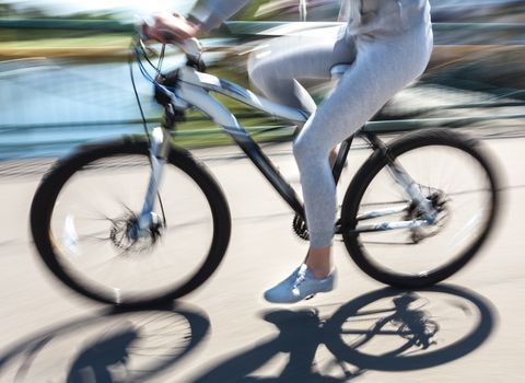 cyclist in traffic on the city roadway. Intentional motion blur
