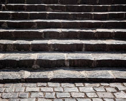Steps on a public walkway. Grungy stone stairway in sun light