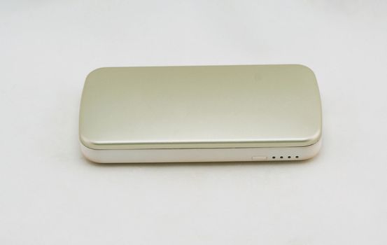 Gold optional external battery for an energy boost placed on a white background.                               