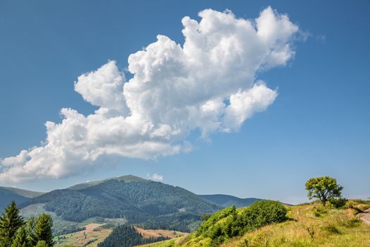 White clouds on blue sky in Carpathian Mountains