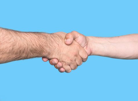 Handshaking. Shaking hands of two male people, isolated on blue