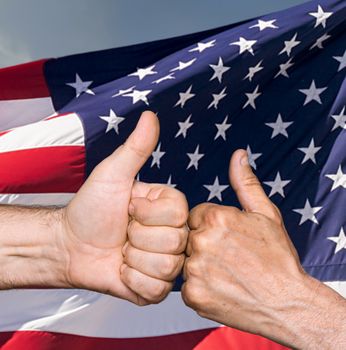 Patriotic concept. Thumbs up sign against of United States of America flag