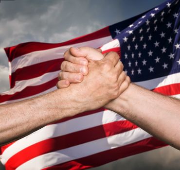 Patriotic concept. Handshaking. The USA flag and shaking hands of two male people