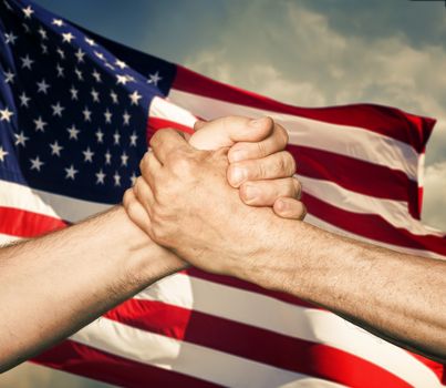 Patriotic concept. Handshaking. The USA flag and shaking hands of two male people