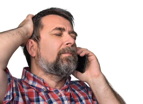 Hard talk. Middle-aged man with closed eyes speaks on a mobile phone isolated on white