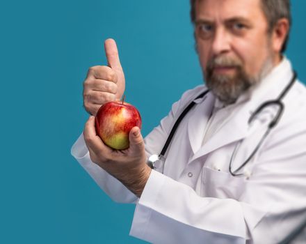 Healthy lifestyles concept. Doctor giving apple for healthy eating and lifestyle or good diet. Focus on apple