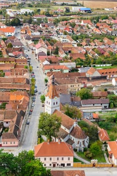 View of Rasnov city from the Rasnov citadel, Romania. Evangelist church 14th century at foreground.