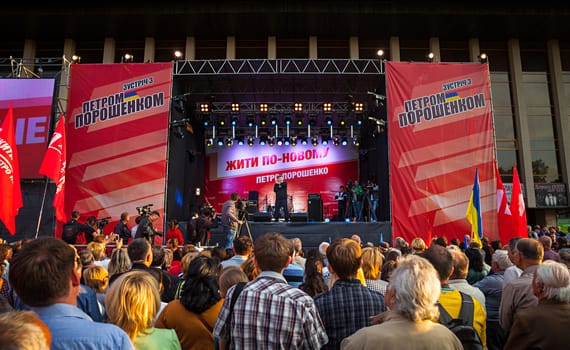 UZHGOROD, UKRAINE - MAY 1, 2014: Most rating Ukrainian presidential candidate Petro Poroshenko speaks at election meeting in Uzhgorod. On the poster: Live in new ways. Petro Poroshenko