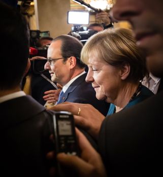 MILAN, ITALY - Oct 17, 2014: German Chancellor Angela Merkel and French President Francois Hollande after the meeting on the ASEM summit of European and Asian leaders in Milan