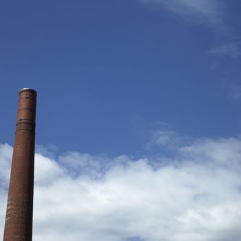 Brown brick chimney and blue sky