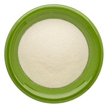 collagen protein powder on an isolated green ceramic bowl, top view